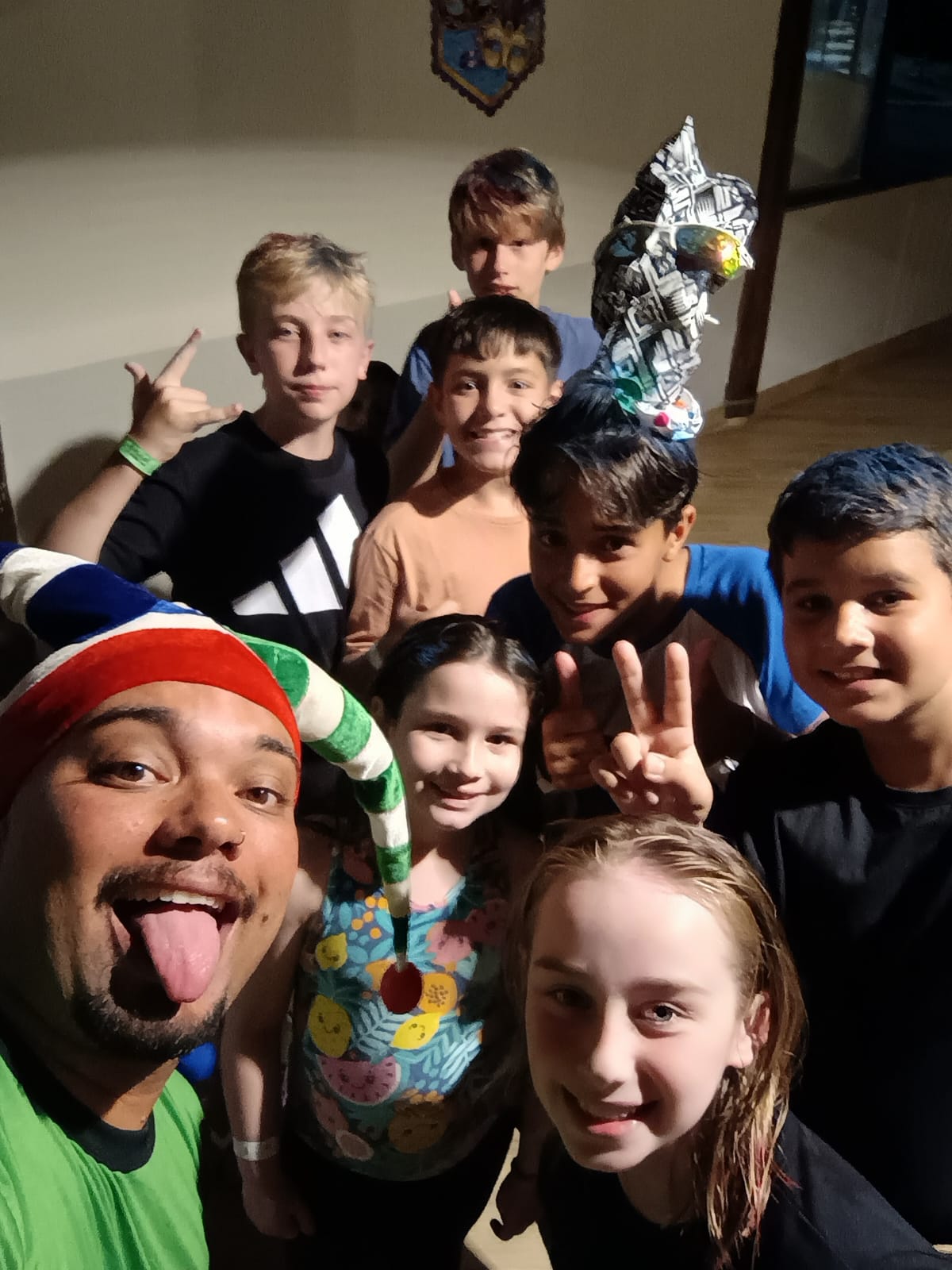 Recreador com crianças em selfie durante atividade noturna